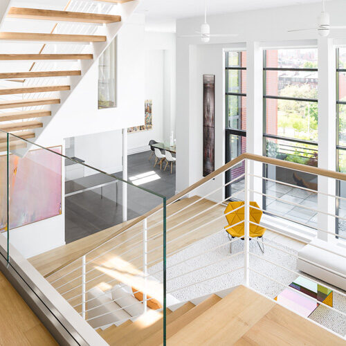 white, multi-level loft with minimalist decor and light wood